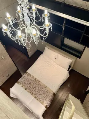 a room with a bed and a chandelier at CoreHOTEL in Tokyo