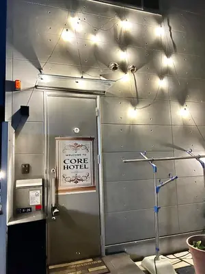 a metal wall with lights on the ceiling at CoreHOTEL in Tokyo