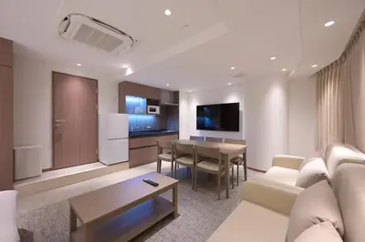 a living room with a couch and a table at COCOYO Hotel \u5927\u585a in Tokyo