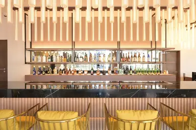 a bar at a restaurant with yellow chairs at COCOYO Hotel \u5927\u585a in Tokyo