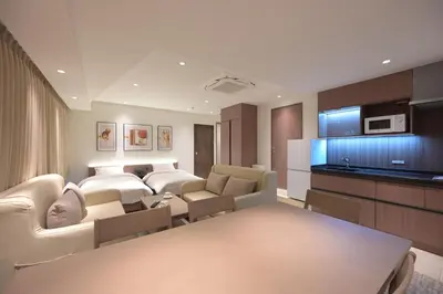 a living room with a couch and a table in a room at COCOYO Hotel \u5927\u585a in Tokyo