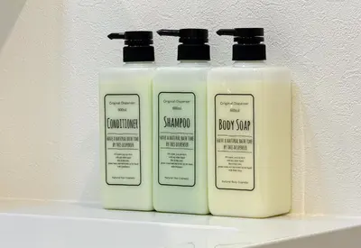 three bottles of shampoo and snow soap on a shelf at \u677e\u6c5f7\u4e01\u76ee\u6238\u5efa in Tokyo