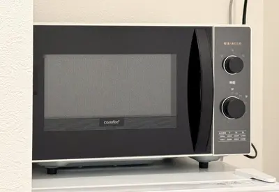 a microwave oven sitting on top of a shelf at \u677e\u6c5f7\u4e01\u76ee\u6238\u5efa in Tokyo