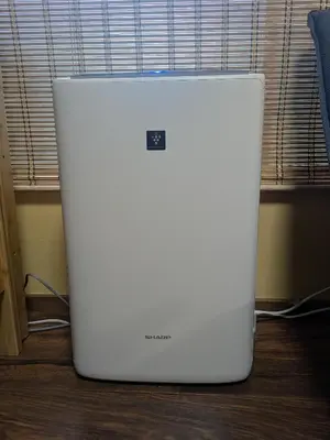 a white refrigerator sitting on top of a wooden floor at Matsuri House 20min to Ueno in Tokyo
