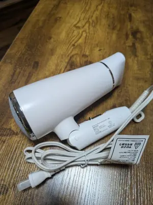 a white object with wires on a wooden table at Matsuri House 20min to Ueno in Tokyo