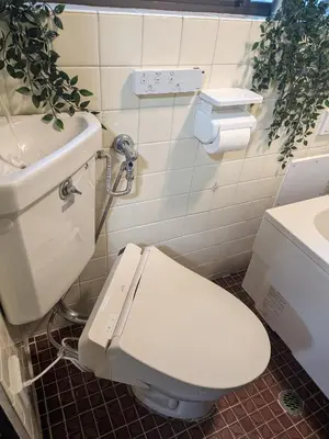 a bathroom with a white toilet and a sink at Matsuri House 20min to Ueno in Tokyo