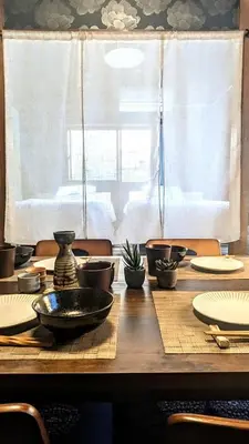 a wooden table with plates and a bowl on it at 20min to Haneda airport Vista Ikegami in Tokyo