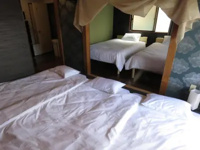 two beds in a room with white sheets at 20min to Haneda airport Vista Ikegami in Tokyo