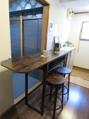 a kitchen with a wooden table and two stools at 20min to Haneda airport Vista Ikegami in Tokyo