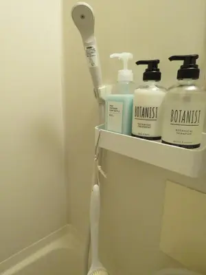 a bathroom with a toothbrush and other bathroom items on a shelf at 20min to Haneda airport Vista Ikegami in Tokyo