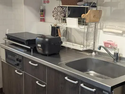 a kitchen counter with a sink and a appliance at 20min to Haneda airport Vista Ikegami in Tokyo