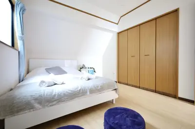 a bedroom with a white bed with wooden cabinets at \u6c60\u888b\u7535\u8f663\u5206\u65b0\u5bbf11\u5206\u6da9\u8c3718\u5206\u94f6\u5ea724\u5206\u99c5\u307e\u3067\u5f92\u6b695\u5206\u8cb8\u5207\u6700\u59278\u4eba in Tokyo