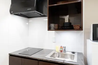 a kitchen with a sink and a microwave at FK Place\u795e\u697d\u5742 in Tokyo