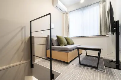 a room with a couch and a mirror and a table at FK Place\u795e\u697d\u5742 in Tokyo