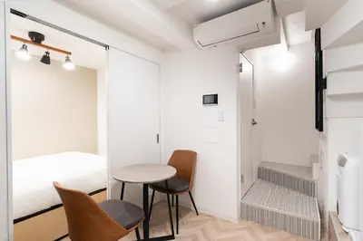 a small room with a table and chairs and a bed at FK Place\u795e\u697d\u5742 in Tokyo