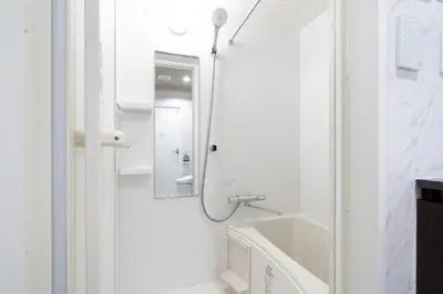 a white bathroom with a sink and a mirror at FK Place\u795e\u697d\u5742 in Tokyo