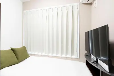 a bedroom with a bed and a large window at FK Place\u795e\u697d\u5742 in Tokyo