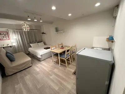 a small living room with a bed and a table at 5minutes from Shinjuku Shin-Okubo Station-k101 in Tokyo