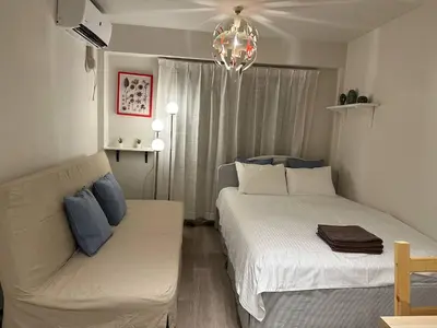 a living room with two beds and a couch at 5minutes from Shinjuku Shin-Okubo Station-k101 in Tokyo