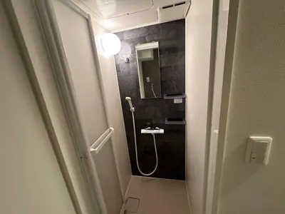 a bathroom with a shower with a sink and a mirror at 5minutes from Shinjuku Shin-Okubo Station-k101 in Tokyo