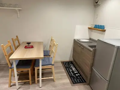 a small kitchen with a table and a refrigerator at 5minutes from Shinjuku Shin-Okubo Station-k101 in Tokyo