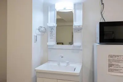 a bathroom with a sink and a mirror at APRO Stay \u54c1\u5ddd in Tokyo