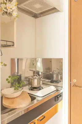 a kitchen with pots and pans on a stove at Lucky House\u65b0\u5bbf21 in Tokyo