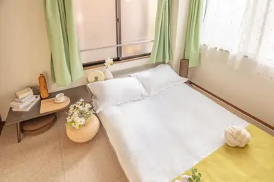 a small bedroom with a bed and a window at Lucky House\u65b0\u5bbf21 in Tokyo