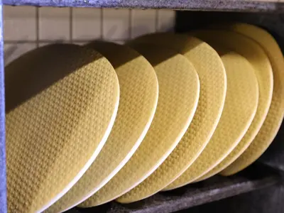 a row of yellow paper plates on a rack at Dormy Inn Ueno Okachimachi in Tokyo
