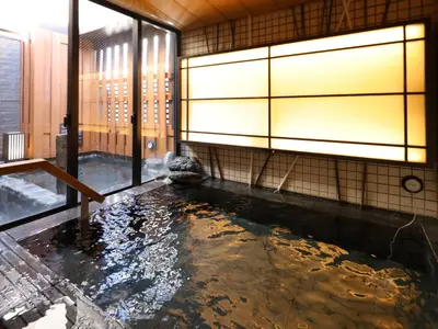 a koi pond in a room with a window at Dormy Inn Ueno Okachimachi in Tokyo