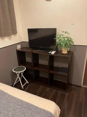 a bedroom with a desk with a television and a plant at Hotel Grand Fort - Vacation STAY 19351v in Tokyo