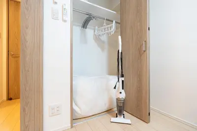 a room with a closet with a door open at \u30a2\u30fc\u30d0\u30f3\u30d1\u30fc\u30af\u672c\u6240\u543e\u59bb\u6a4b in Tokyo