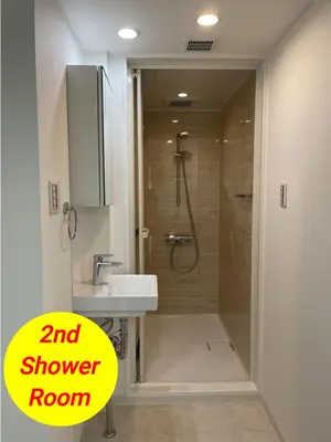 a bathroom with a shower with a sink and a shower room at Entire Hotel Beside Asakusa, Ueno, Akihabara and Tokyo Skytree tower between 3 Train Stations and Contains 3 Bedrooms, 2 Bathrooms and 2 toilets for 14 guests in Tokyo