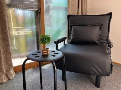 a chair sitting next to a window with a table at Entire Hotel Beside Asakusa, Ueno, Akihabara and Tokyo Skytree tower between 3 Train Stations and Contains 3 Bedrooms, 2 Bathrooms and 2 toilets for 14 guests in Tokyo