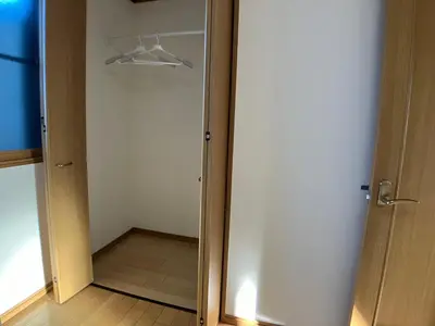 a closet with a white door at Entire Hotel Beside Asakusa, Ueno, Akihabara and Tokyo Skytree tower between 3 Train Stations and Contains 3 Bedrooms, 2 Bathrooms and 2 toilets for 14 guests in Tokyo
