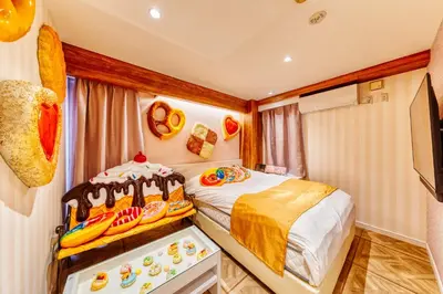 a small bedroom with a bed and a tv at SweetsHotel Ikebukuro -Adult Only in Tokyo