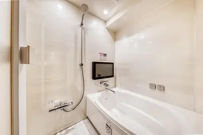 a white bathroom with a tub and a sink at SweetsHotel Ikebukuro -Adult Only in Tokyo