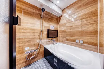 a bathroom with a bath tub and a tv at SweetsHotel Ikebukuro -Adult Only in Tokyo