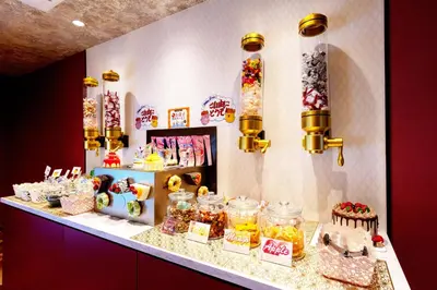a candy store with cakes and desserts on a counter at SweetsHotel Ikebukuro -Adult Only in Tokyo