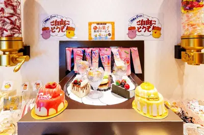 a display of cakes and desserts on a shelf at SweetsHotel Ikebukuro -Adult Only in Tokyo
