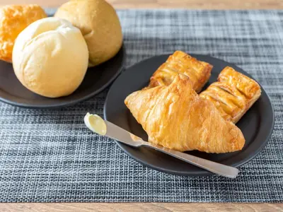 two plates of pastries and bread on a table at Super Hotel Ikebukuro-Eki Kitaguchi in Tokyo