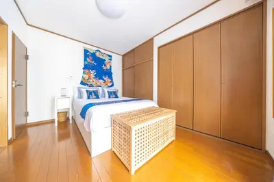 a bedroom with a large bed and wooden cabinets at NEW Koenji House 3BR Family Friendly Haven in Tokyo