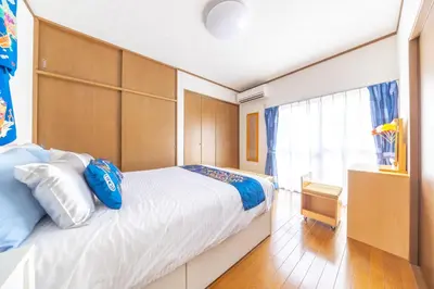 a bedroom with a large bed and a window at NEW Koenji House 3BR Family Friendly Haven in Tokyo