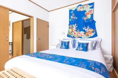 a bedroom with a large bed with blue and white at NEW Koenji House 3BR Family Friendly Haven in Tokyo