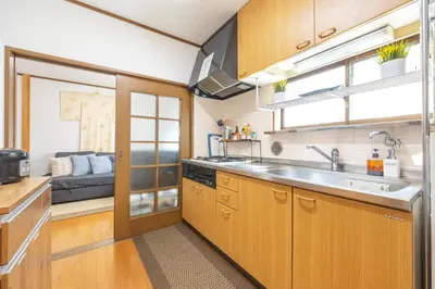 a kitchen with wooden cabinets and a sink at NEW Koenji House 3BR Family Friendly Haven in Tokyo