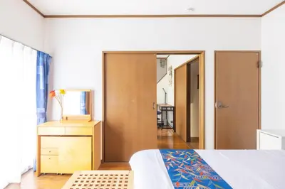 a bedroom with a bed and a dresser and a mirror at NEW Koenji House 3BR Family Friendly Haven in Tokyo