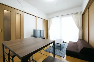 a living room with a table and a television at Voere\u5927\u4e95\u753a 201 in Tokyo