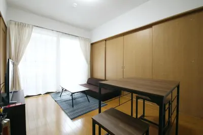 a living room with a wooden table and a couch at Voere\u5927\u4e95\u753a 201 in Tokyo