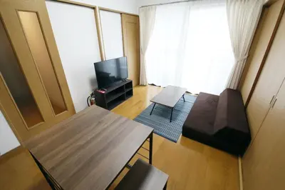 a living room with a couch and a television at Voere\u5927\u4e95\u753a 201 in Tokyo