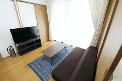 a living room with a couch and a flat screen tv at Voere\u5927\u4e95\u753a 201 in Tokyo